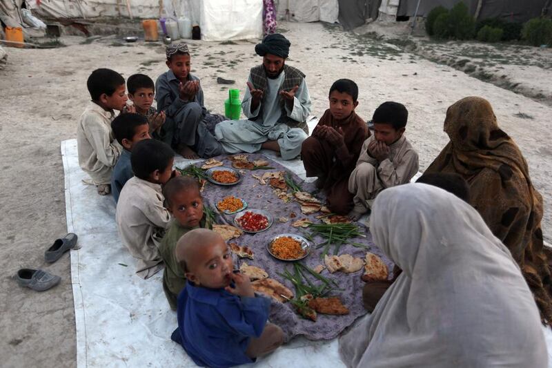 An internally displaced Afghan family breaks their fast during the holy month of Ramadan in Kabul, Afghanistan, on June 20, 2015. Devout Muslims throughout the world are marking the month of Ramadan, the holiest month in the Islamic calendar during which devotees fast from dawn till dusk. Rahmat Gul / AP photo