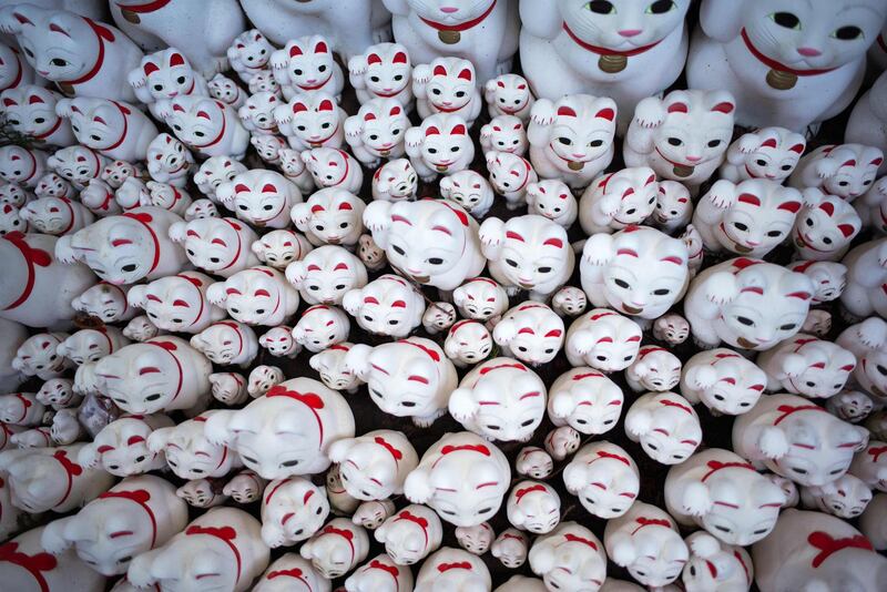 Cat figurines called maneki-neko are stacked together at the Gotokuji temple in Tokyo. Martin Bureau/AFP