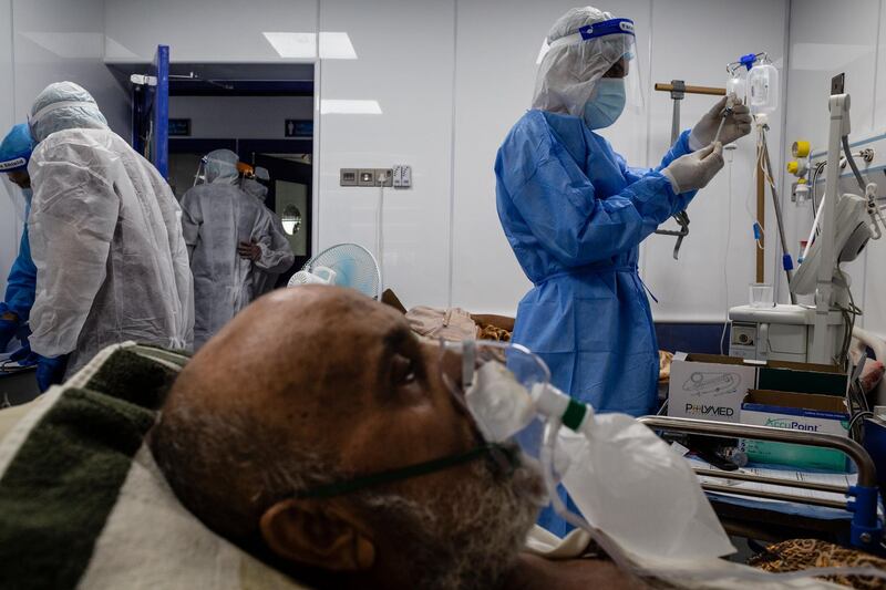 NAJAF, IRAQ - AUGUST 31: Doctors check on a patient suffering from coronavirus at the Dr. Hassan Haloos hospital on August 31, 2020 in Najaf, Iraq. On September 4, Iraq recorded 5,036 coronavirus cases, its biggest daily increase since the start of the outbreak.  The surge has prompted warnings from Iraq's health minister and WHO that the country could be on the verge of a health crisis as pressure mounts on the already strained healthcare system. Since the first case was recorded in February, Iraq has recorded 252,075 total cases and 7,359 deaths. (Photo by Hawre Khalid/Getty Images)