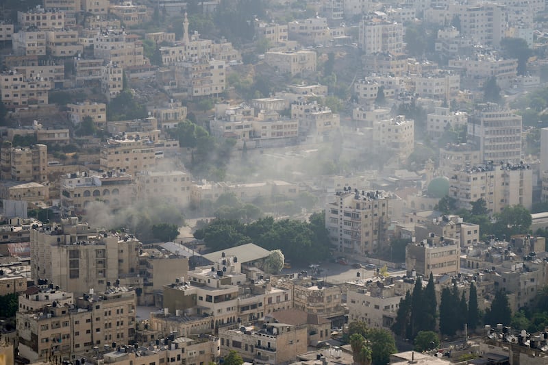 Smoke rises above buildings during the Israeli army operation in Nablus. AP Photo