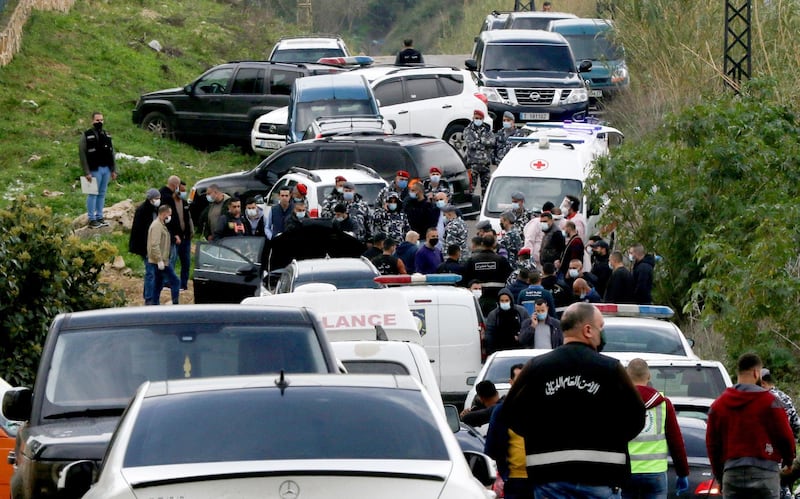 Members of the security forces gather as medics take away the body of prominent Lebanese activist and intellectual Lokman Slim from the spot where he was found dead in his car, near the southern Lebanese city of Sidon. AFP