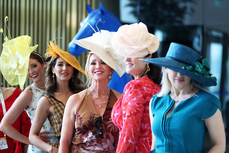 Women line up to show off their Dubai World Cup looks. Pawan Singh / The National