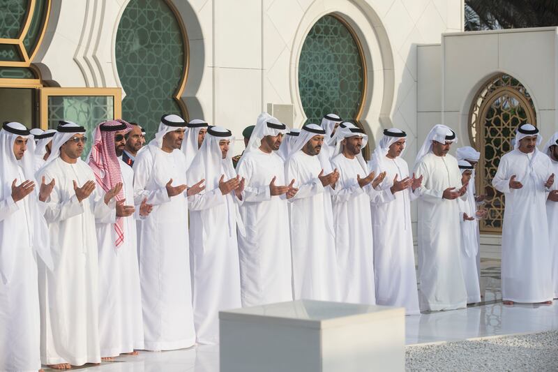 ABU DHABI, UNITED ARAB EMIRATES - June 25, 2017: HH Sheikh Mohamed bin Zayed Al Nahyan, Crown Prince of Abu Dhabi and Deputy Supreme Commander of the UAE Armed Forces (6th L), prays at the grave of his father the late HH Sheikh Zayed bin Sultan bin Zayed Al Nahyan, President of the United Arab Emirates, during  Eid Al Fitr prayers at the Sheikh Zayed Grand Mosque. Seen are (L-R) HH Sheikh Khaled bin Zayed Al Nahyan, Chairman of the Board of Zayed Higher Organization for Humanitarian Care and Special Needs (ZHO), HH Sheikh Mansour bin Zayed Al Nahyan, UAE Deputy Prime Minister and Minister of Presidential Affairs, HH Sheikh Tahnoon bin Zayed Al Nahyan, UAE National Security Advisor, HH Sheikh Saeed bin Zayed Al Nahyan, Abu Dhabi Ruler's Representative, HH Sheikh Hazza bin Zayed Al Nahyan, Vice Chairman of the Abu Dhabi Executive Council, HH Sheikh Mohamed bin Zayed Al Nahyan, Crown Prince of Abu Dhabi and Deputy Supreme Commander of the UAE Armed Forces, HE Dr Mohamed Matar Salem bin Abid Al Kaabi, Chairman of the UAE General Authority of Islamic Affairs and Endowments, HH Sheikh Nahyan Bin Zayed Al Nahyan, Chairman of the Board of Trustees of Zayed bin Sultan Al Nahyan Charitable and Humanitarian Foundation, HH Lt General Sheikh Saif bin Zayed Al Nahyan, UAE Deputy Prime Minister and Minister of Interior, HH Sheikh Hamed bin Zayed Al Nahyan, Chairman of the Crown Prince Court of Abu Dhabi and Abu Dhabi Executive Council Member, and HH Sheikh Abdullah bin Zayed Al Nahyan, UAE Minister of Foreign Affairs and International Cooperation. 
( Ryan Carter / Crown Prince Court - Abu Dhabi )
---