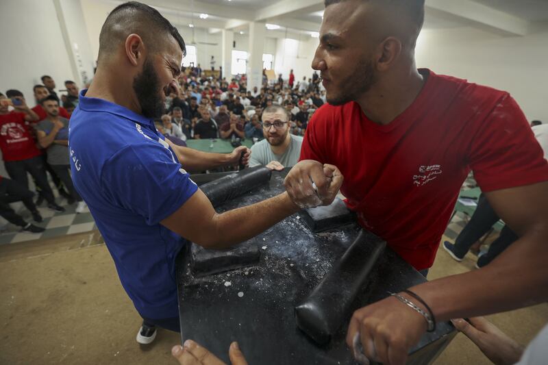 Palestinians take part in a two-day arm-wrestling championship in Rammun village, east of Ramallah, in the West Bank.