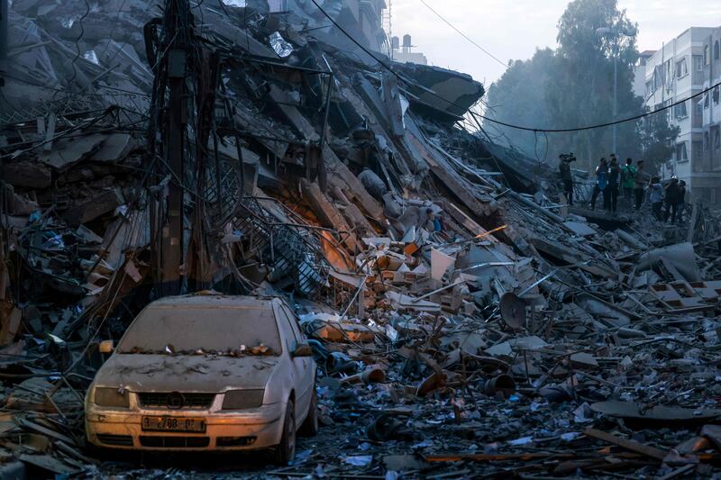 A car amid the rubble of a destroyed tower after an Israeli air strike in Gaza city. AFP