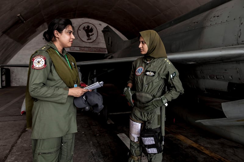 Ayesha Farooq, 26, (R) Pakistan's only female war-ready fighter pilot, talks with avionics engineer Anam Hassan, 24, at Mushaf base in Sargodha, north Pakistan June 7, 2013. Farooq, from Punjab province's historic city of Bahawalpur, is one of 19 women who have become pilots in the Pakistan Air Force over the last decade - there are five other female fighter pilots, but they have yet to take the final tests to qualify for combat. A growing number of women have joined Pakistan's defence forces in recent years as attitudes towards women change. Picture taken June 7, 2013.  REUTERS/Zohra Bensemra (PAKISTAN - Tags: MILITARY SOCIETY) *** Local Caption ***  ZOH13_PAKISTAN-AIRF_0612_11.JPG