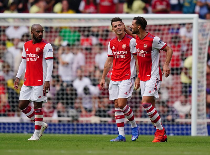 Arsenal's Granit Xhaka, centre, is congratulated after scoring.