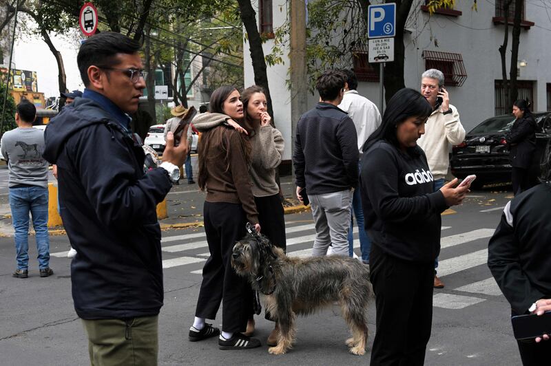 People wait in the street after an earthquake shook Mexico City. AFP