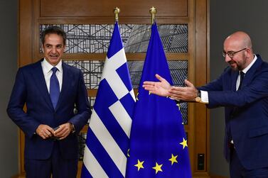 European Council President Charles Michel gestures as he greets Greek Prime Minister Kyriakos Mitsotakis ahead of the second face-to-face European Union summit since the coronavirus disease (COVID-19) outbreak, in Brussels, Belgium October 1, 2020. Reuters