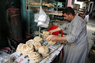 An Egyptian worker arranges bread at a bakery in Cairo, Egypt. EPA