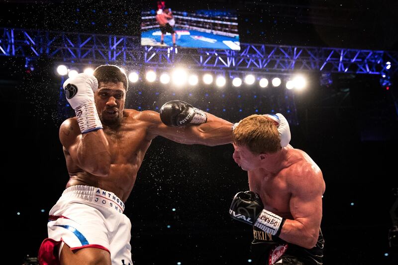 Anthony Joshua and Alexander Povetkin trade punches during the World Heavyweight Championship title fight at Wembley Stadium in London, England. Richard Heathcote/Getty Images