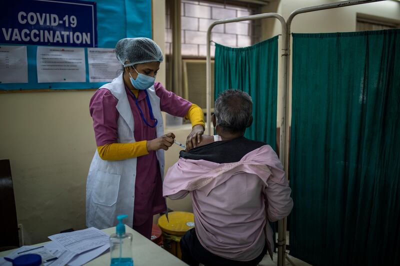A health worker administers a Covid-19 vaccine to a municipal worker at a private hospital in New Delhi, India. AP Photo