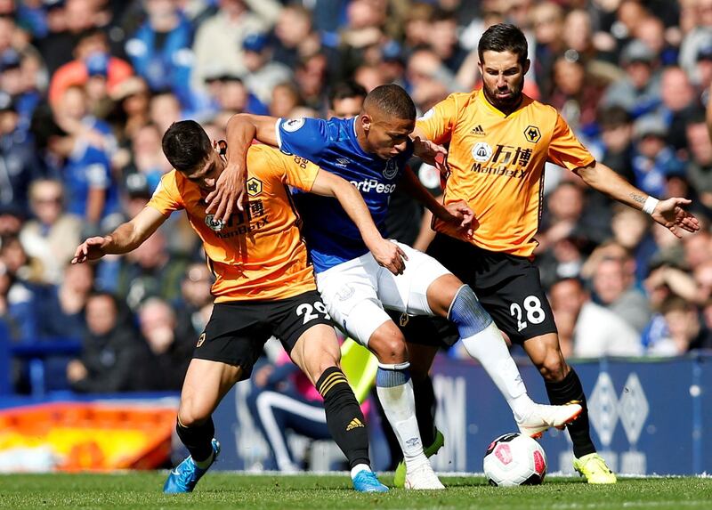 Everton's Richarlison in action with Wolverhampton Wanderers' Ruben Vinagre and Diogo Jota. Reuters