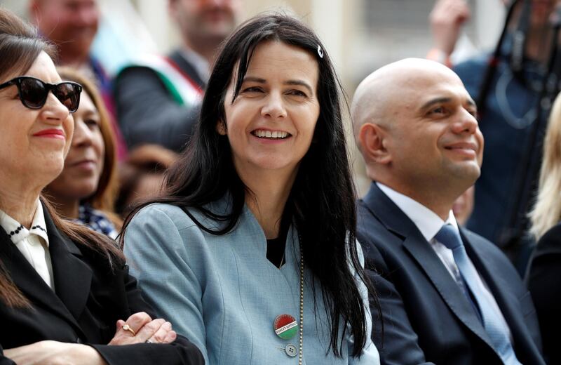 British artist Gillian Wearing (C) listens to a speaker during the unveiling of her sculpture of suffragist and women's rights campaigner Millicent Fawcett in Parliament Square in London on April 24, 2018. - The first statue of a woman on Parliament Square in London was to be unveiled on April 24 to celebrate the 100th anniversary of women winning the right to vote in Britain. The statue of women's rights campaigner Millicent Fawcett will stand alongside those of 11 men, including Britain's wartime leader Winston Churchill, Indian independence icon Mahatma Gandhi and anti-apartheid leader Nelson Mandela. (Photo by Adrian DENNIS / AFP)