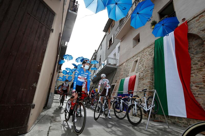 epa09074072 Slovenian rider Tadej Pogacar (L) of the UAE Team Emirates at the start of the 5th stage of the 2021 Tirreno Adriatico cycling race,  over 205km between Castellalto and Castelfidardo, Italy, 14 March 2021.  EPA/LUCA BETTINI