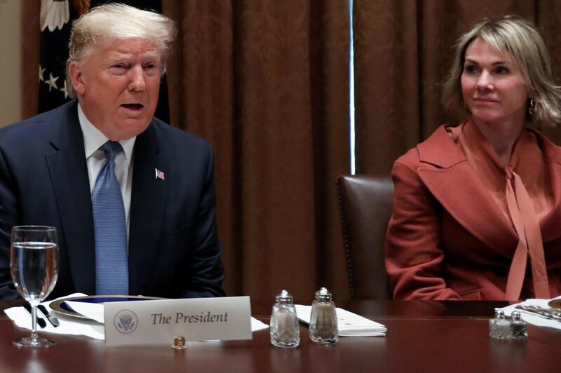 FILE PHOTO: U.S. President Donald Trump — with full-sized salt and pepper shakers — is flanked by U.S. Ambassador to the United Nations Kelly Craft, with the smaller salt and pepper shakers used by Trump’s guests, as he hosts a lunch for ambassadors to the U.N. Security Council at the White House in Washington, U.S. December 5, 2019. REUTERS/Jonathan Ernst/File Photo