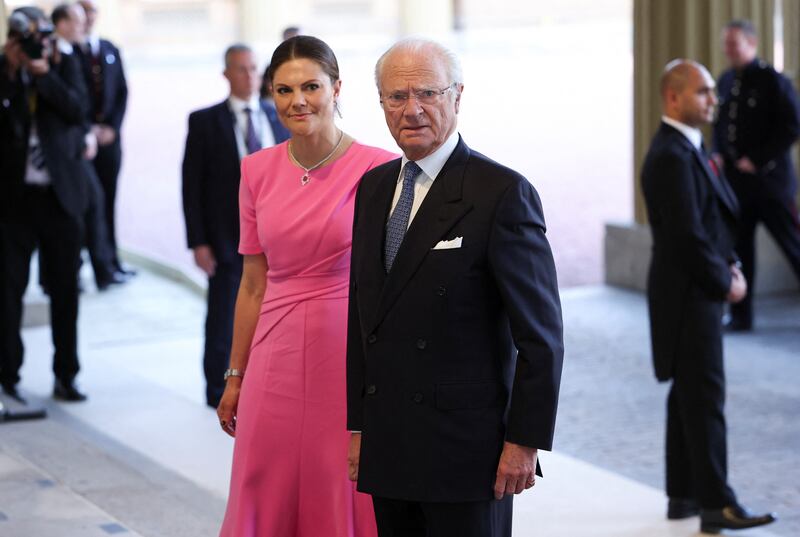 King Carl Gustaf of Sweden and Crown Princess Victoria arrive at the reception. Reuters