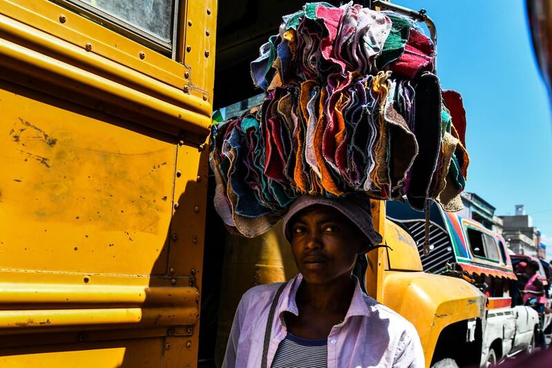 A woman sells cloth in a local market in Port-au-Prince, Haiti. AFP