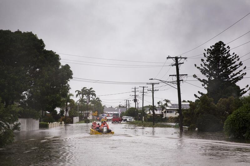 Volunteers rescue residents in the Rosslea suburb of Townsville in Queensland state.  EPA