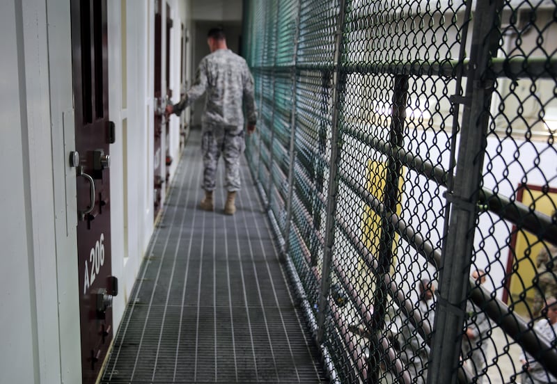 A US soldier walks past unoccupied detainee cells inside Camp 6 at Guantanamo Bay in Cuba. AP