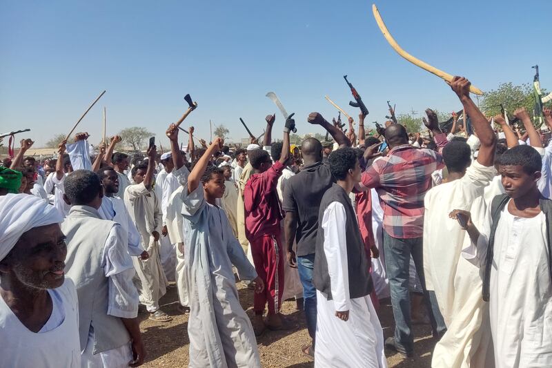 Supporters of the Sudanese armed popular resistance, which backs the army, wave weapons in the air during a rally in Gedaref. AFP