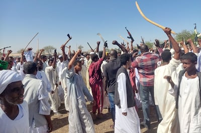 Supporters of the Sudanese armed popular resistance, which backs the army, wave automatic rifles, axes and batons as they rally in Gedaref on March 3, 2024. AFP
