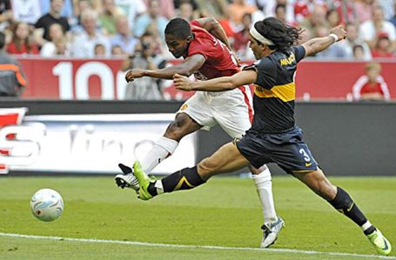 Manchester United's Ecuadorian winger Antonio Valencia, left, scores his first goal for the club as Boca Juniors defender Morel Rodriguez tries to challenge during the Audi Cup semi-final at the Allianz Arena in Munich.