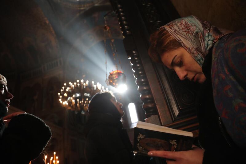 Georgian Orthodox believers pray during Epiphany celebrations at the Sioni Cathedral in Tbilisi. EPA