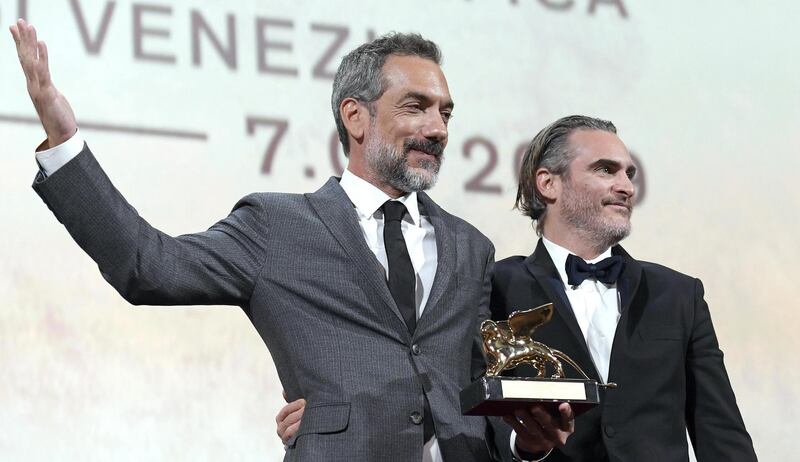 epa07826296 US director Todd Phillips (L) holds the Golden Lion award for his movie 'Joker' as he poses US actor Joaquin Phoenix during the awarding ceremony of the 76th annual Venice International Film Festival, in Venice, Italy, 07 September 2019. The festival runs from 28 August to 07 September.  EPA/CLAUDIO ONORATI