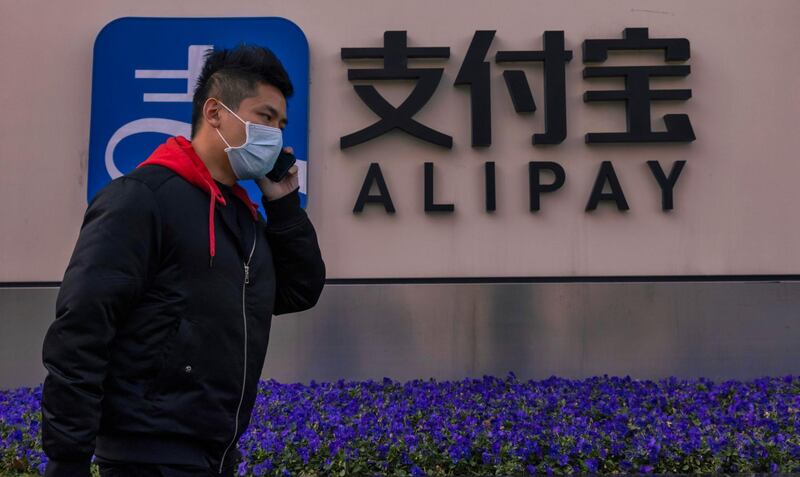 epa08980879 A man walks in front of the Alipay building in Shanghai, China, 02 February 2021. Alibaba Group Holding Limited, the Chinese e-commerce giant, will announce its financial results for the third quarter on 02 February. In the second quarter of 2020, Alibaba had earnings of 29.9 percent. Ant group's Alipay is an affiliate company of the Alibaba Group founded by billionaire Jack Ma.  EPA/ALEX PLAVEVSKI