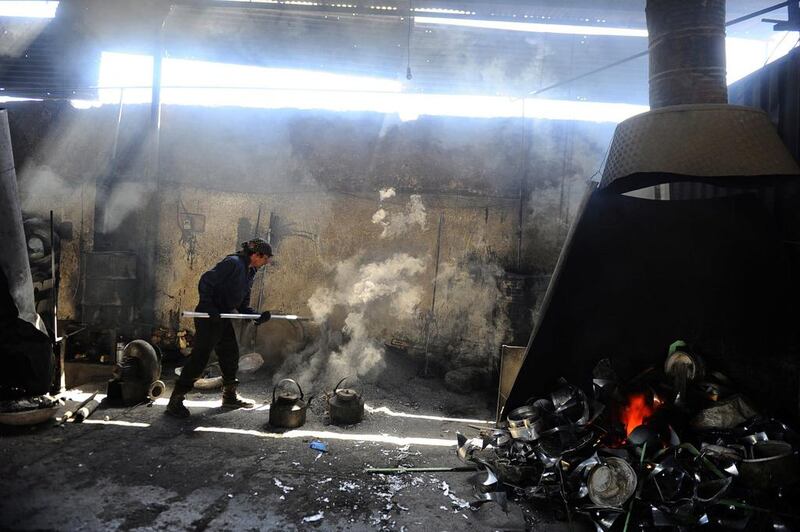 An Afghan labourer works at an aluminium workshop in Herat.