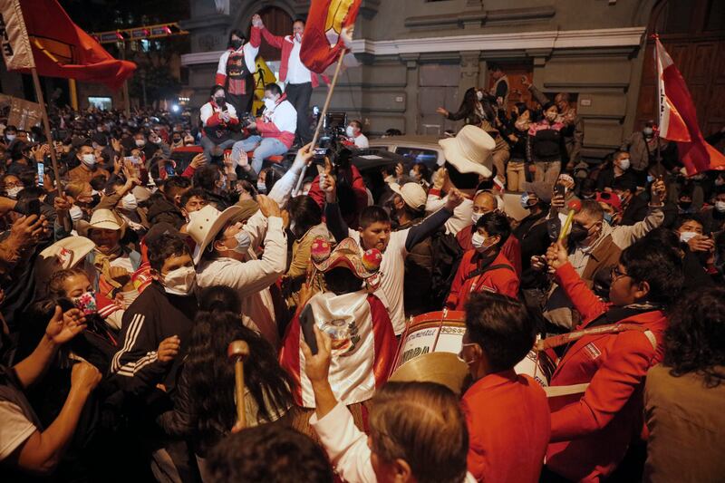 Supporters of Pedro Castillo celebrate after he was declared president-elect of Peru by the election authorities, in Lima.
