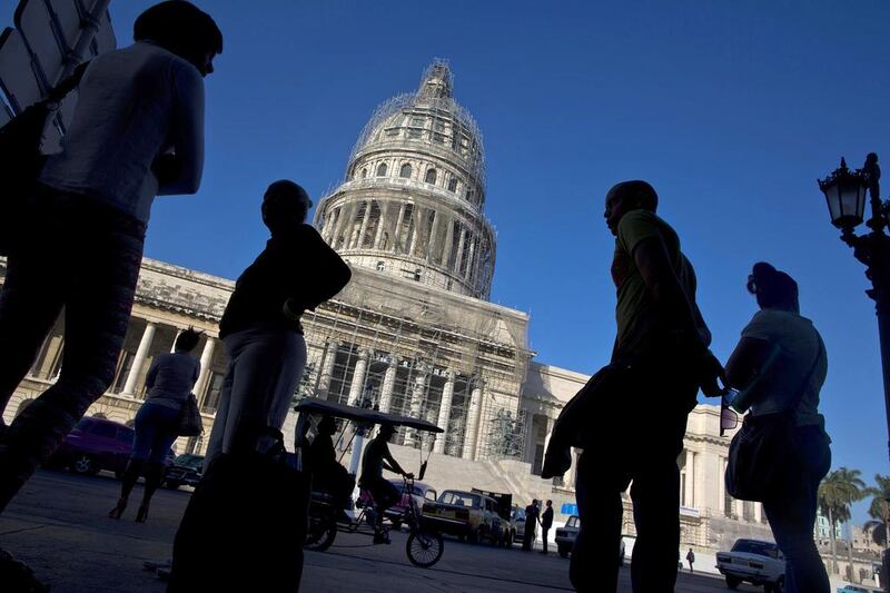 People line up to take the bus outside the Capitolio in Havana, Cuba. Ramon Espinosa / AP Photo
