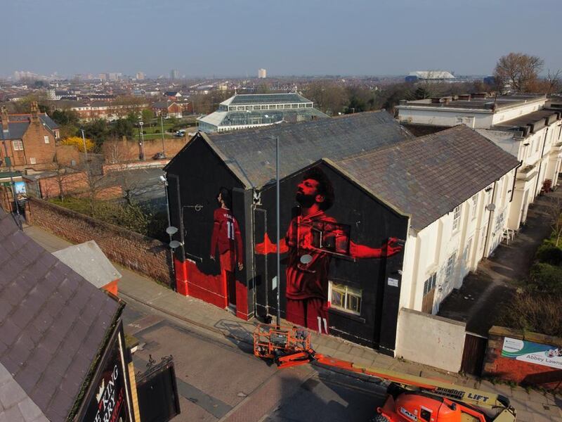 A mural by local artist John Culshaw of Liverpool star Mohamed Salah is close to completion at Anfield Road. PA