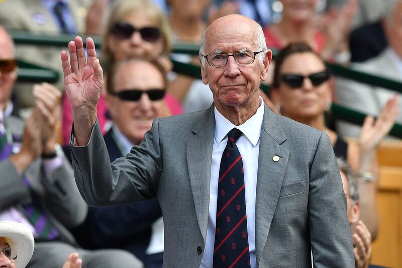 Sir Bobby Charlton salutes the crowd as he takes his seat in the royal box on Centre Court to watch Spain's Rafael Nadal play in 2018. AFP