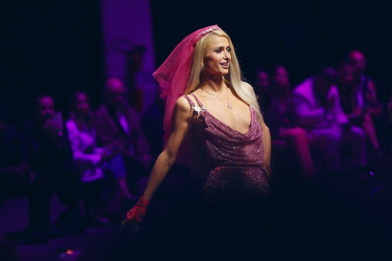 Paris Hilton makes a surprise guest appearance to close the Versace show. Getty