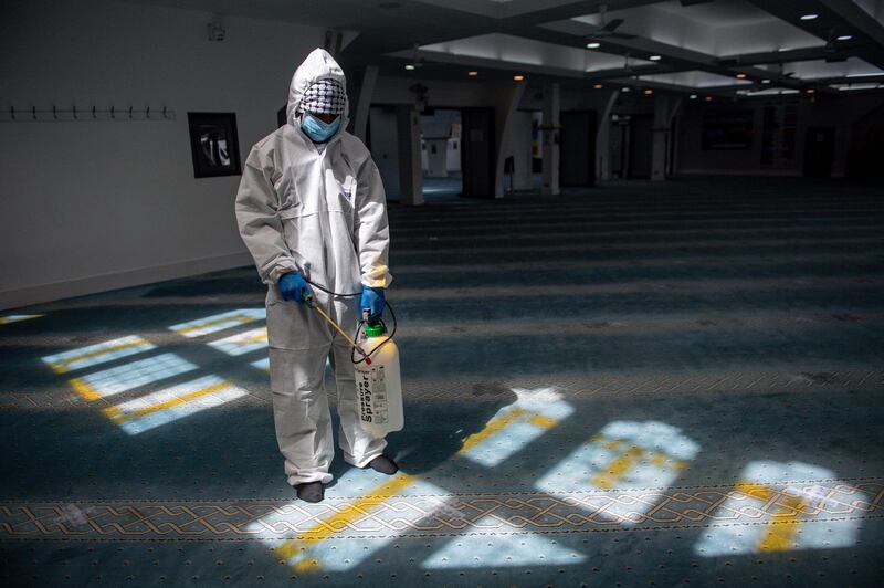 A staff member disinfects prayer rooms, ahead of Eid Al Fitr at the Green Lane mosque in Birmingham. AP Photo