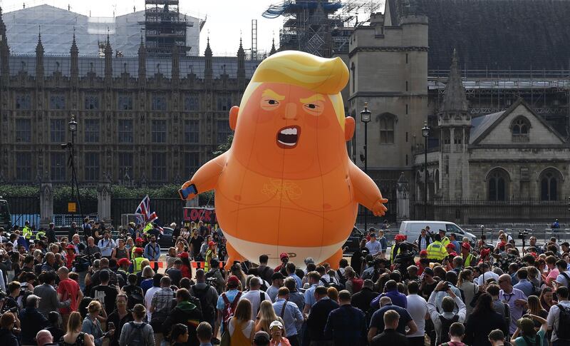 epa06885235 The 'Donald Trump Baby Blimp' balloon flies over Parliament Square during a protest in London, Britain, 13 July 2018. The inflatable dubbed 'Trump Baby' tied to a spot in Parliament Square is to kick off a day of protests against US President Donald J. Trump's visit. Trump is on a working visit to Britain.  EPA/ANDY RAIN