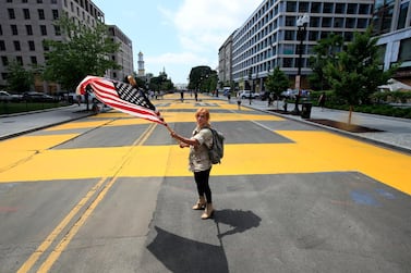 City workers and activists painted the words "Black Lives Matter" in enormous bright yellow letters on the street leading to the White House. AP