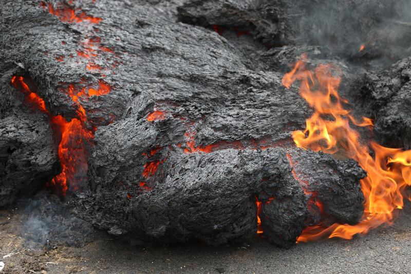 Lava burns across a road in the Leilani Estates subdivision near Pahoa, Hawaii. Caleb Jones / AP Photo