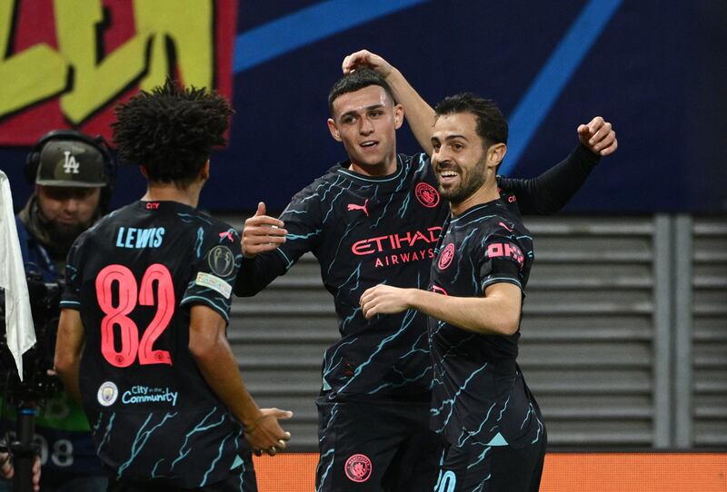Manchester City's Phil Foden celebrates scoring their first goal with Bernardo Silva and Rico Lewis. Reuters