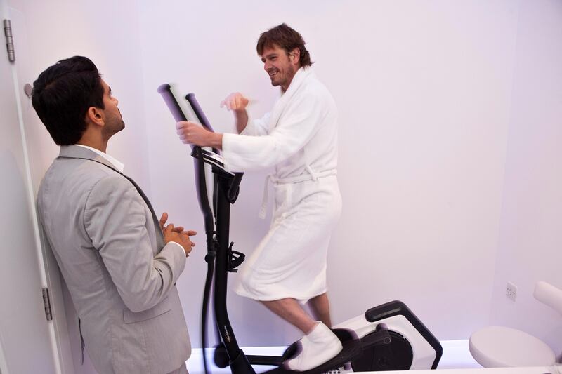 DUBAI, UNITED ARAB EMIRATES,  JULY 07, 2013. Benny Parihar, Partner of Cryo Health chats to journalist Neil Vorano after he tried out the newly launched Cryo full body treatment at the Cryo Health Spa Dubai, located in the Emirates Towers Boulevard. neil is using a stepper cycle to warm up after the treatment. (ANTONIE ROBERTSON / The National) Journalist Neil Vorano