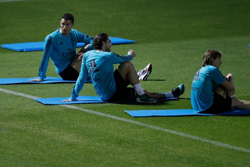 Real Madrid's Cristiano Ronaldo, left, Mateo Kovacic, centre, and Luka Modric stretch during a training session. Hassan Ammar / AP Photo