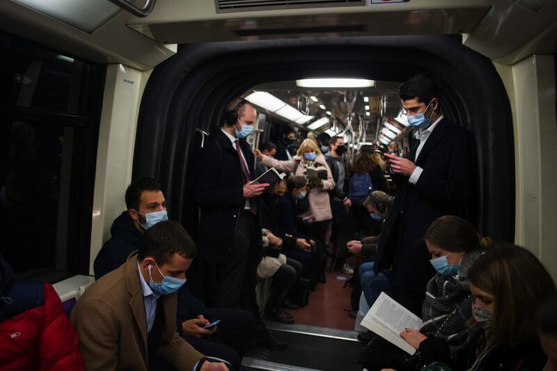 Commuters wearing masks on a busy metro train in Paris, France. Bloomberg
