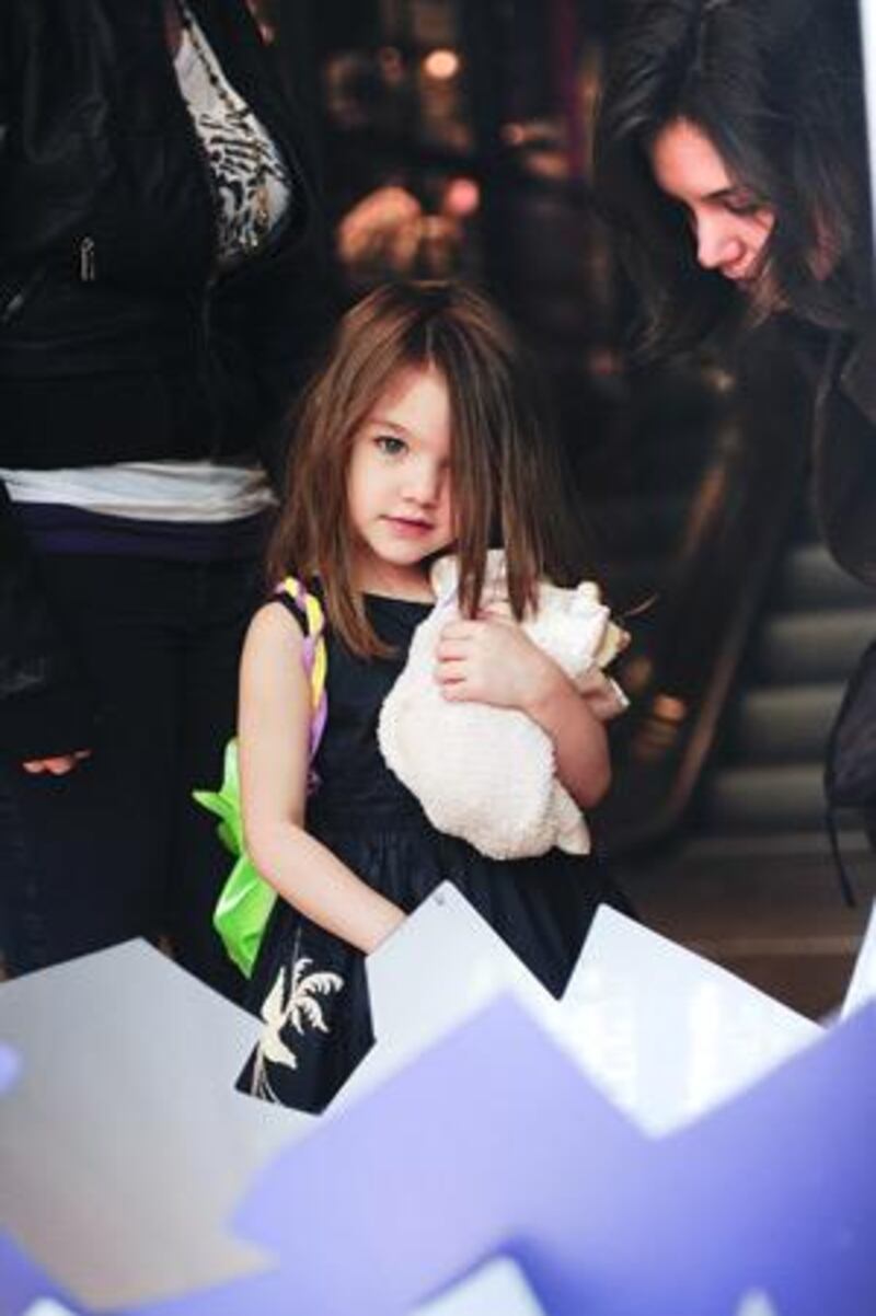 Suri Cruise's parents have said they can't talk her out of wearing her silver high heels.