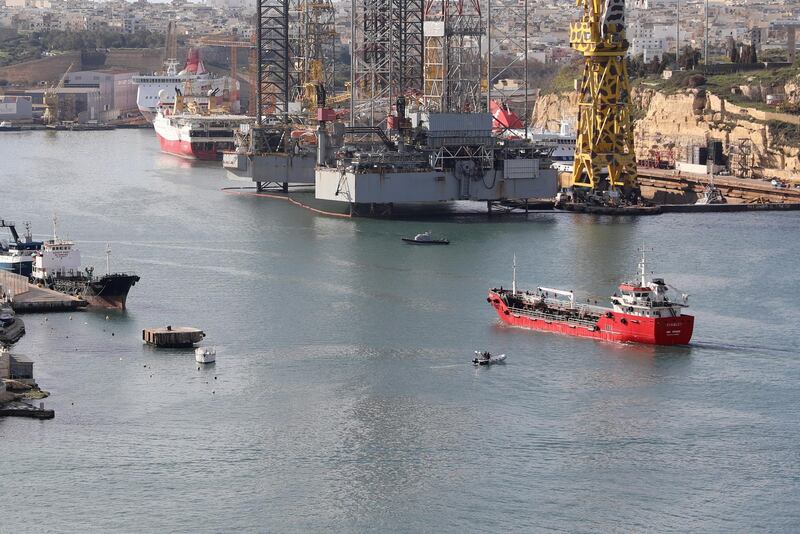 epaselect epa07468068 The merchant ship Elhiblu 1 (R, red), is guided into a harbor after being retaken by Maltese Armed Forces after being hijacked by migrants, at Boiler Warf, Grand Harbor, Senglea, Malta, 28 March 2019. According to media reports, the ship was carrying 108 migrants and refugees who had been rescued off the coast of Libya. When the migrants learned that the ship would be returning to Libya, they took control of the vessel from the crew. Maltese Armed Forces monitored the progress of the ship and retook it. There were no immediate reports of any injuries.  EPA/ANNE AQUILINA