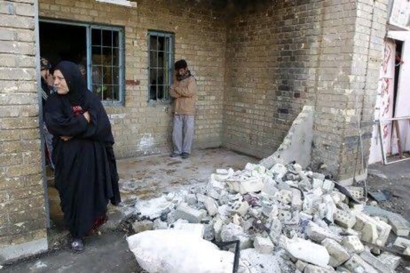 A woman stands beside the rubble in the Shiite Zaafaraniya neighbourhood of Baghdad in January, after a suicide bomber detonated an explosive-filled taxi near a funeral procession, killing 31 people.