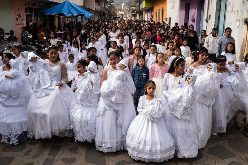 Girls dressed in white and carrying a baby Jesus during the traditional 'Three Wise Men Parade' in Miahuatlan, Mexico. Getty Images