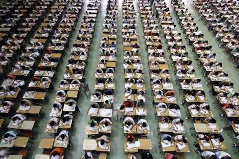 Students take their examination in an exam hall in Dongguan University of Technology, in south China's Guangdong province, July 9, 2007. Around 1,200 students took their English examination in a large hall so as to prevent exam fraud. Picture taken July 9, 2007. REUTERS/China Daily (CHINA) CHINA OUT