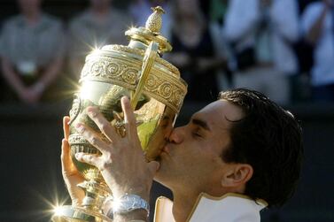 FILE PHOTO: Roger Federer of Switzerland kisses his trophy after defeating Andy Roddick of the U.S. in their Gentlemen's Singles finals match at the Wimbledon tennis championships in London, July 5, 2009. REUTERS/Stefan Wermuth/File Photo